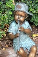 bronze statue of a child with a flute