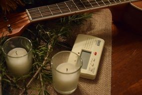 candles and a guitar on the table