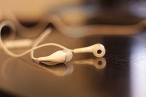 white headphones are lying on the table