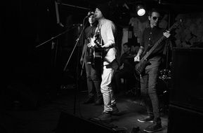 black and white photo of young rock singers at a concert