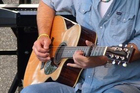 man playing guitar in the street