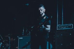 dark photo of a rock singer on stage