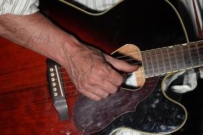 an experienced musician plays the guitar