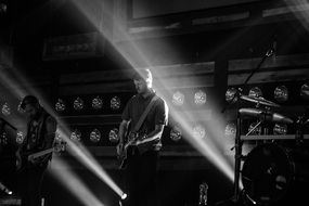 guitarists on scene, black and white