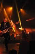 Guitarist on stage in the light of soffits