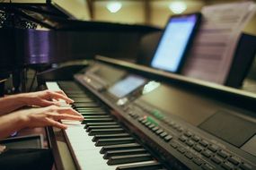 human hands playing the piano