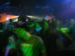 dancing in a nightclub in colorful lighting