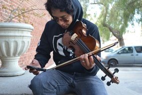 a young man plays the violin
