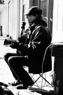 street musician black and white photo