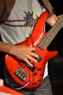 Man is playing on the electric guitar