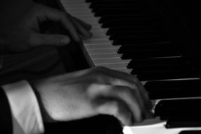 hands on piano black and white photo