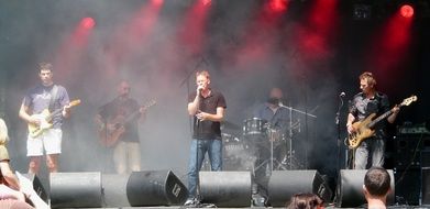 vocalist in the center of the stage at a concert