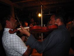 Violin in the hands of men on perfomance