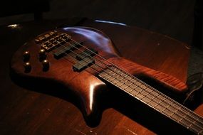 brown bass guitar on the table close-up