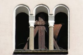 Arched windows against church bell