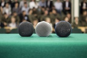 three microphones lay side by side