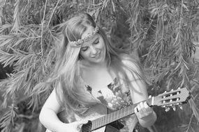 black and white image of a girl who plays the guitar