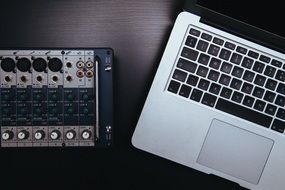 dj mixer and laptop on a table