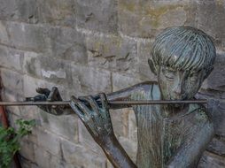 statue of young man with flute