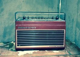 retro radio on an old table by the wall