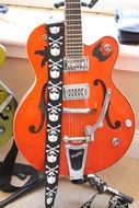 electric guitar with belt skulls