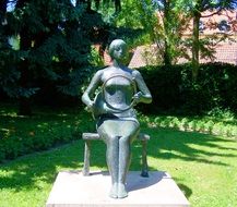 female bronze statue with musical instrument