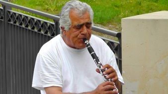 a man plays a professional flute in the park