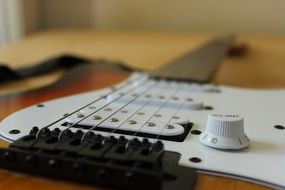 strings of a white electric guitar close-up