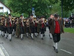 bavarian brass music band parading on road in germany, nesselwang