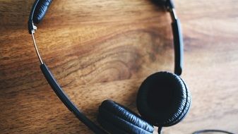 black headphones on a wooden table