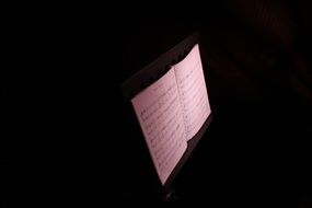 book with musical notes in the dark