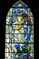 stained glass window with illustration of an angel with guitar