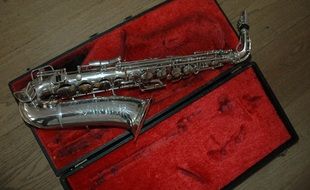 silver saxophone on the suitcase