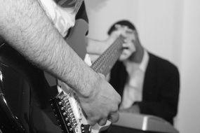 black and white picture of a man playing guitar