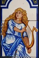 muse with harp on the tile