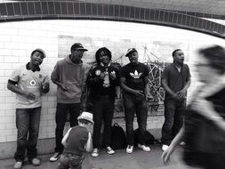 five african young men busking at wall, uk, england, london