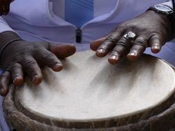 black musician plays the drum