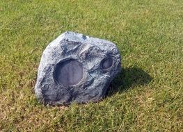 camouflaged stone speaker on lawn