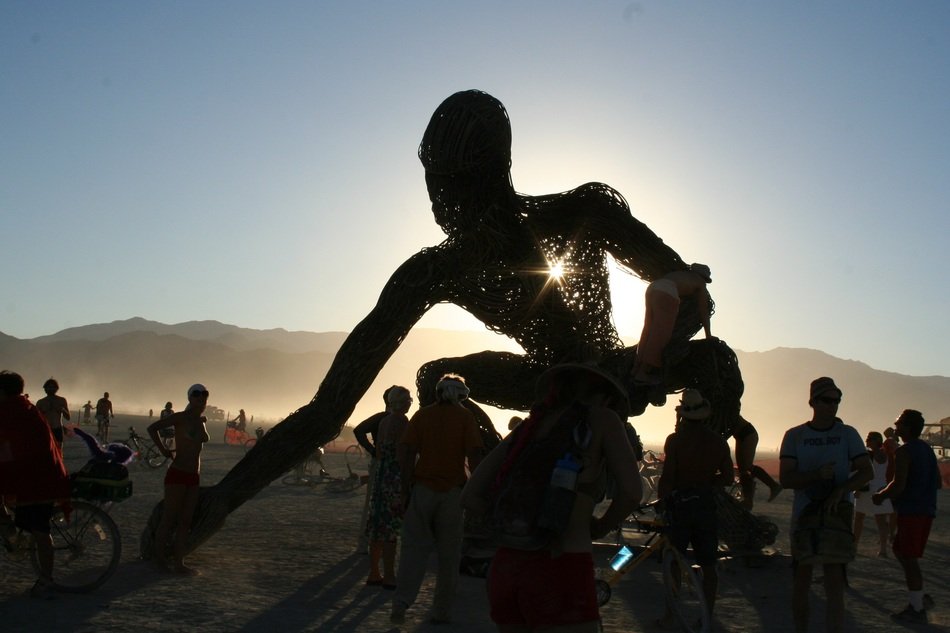 sculpture of a giant on a background of mountains