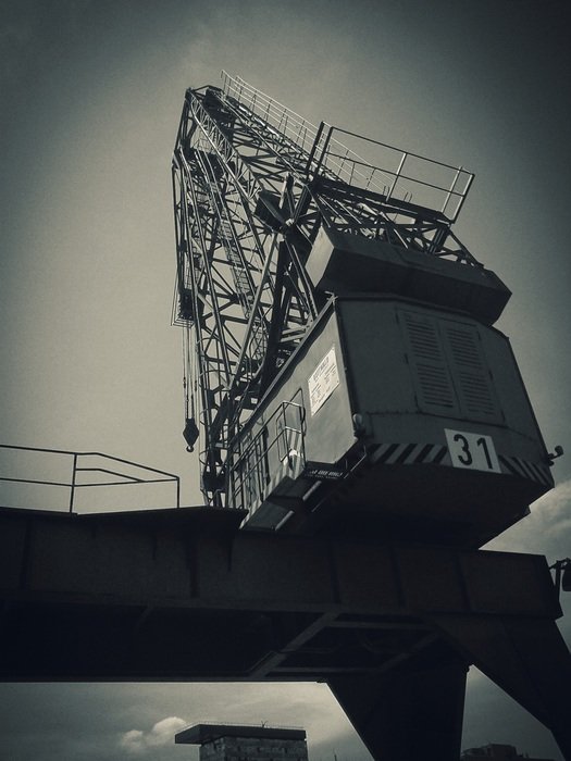 bottom view of an industrial crane in the port