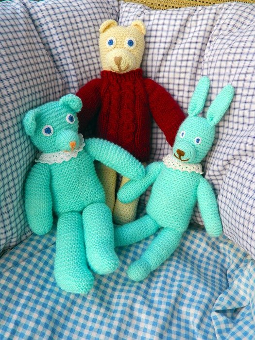 three soft toys on the chair