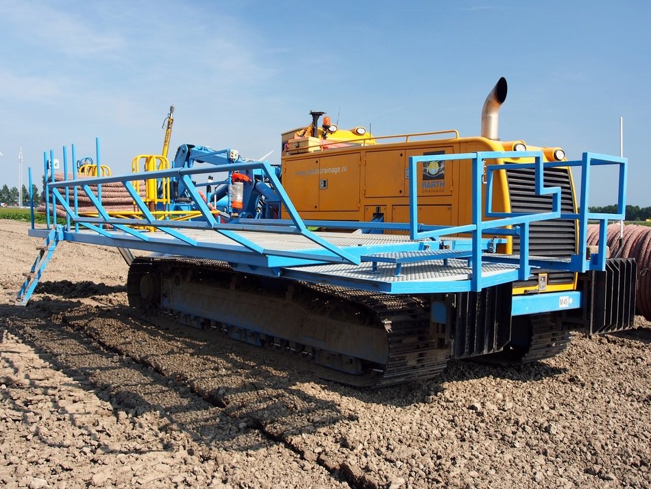 Earth-moving machine among the field