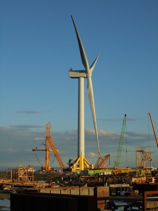 Wind turbine against the background of an industrial district