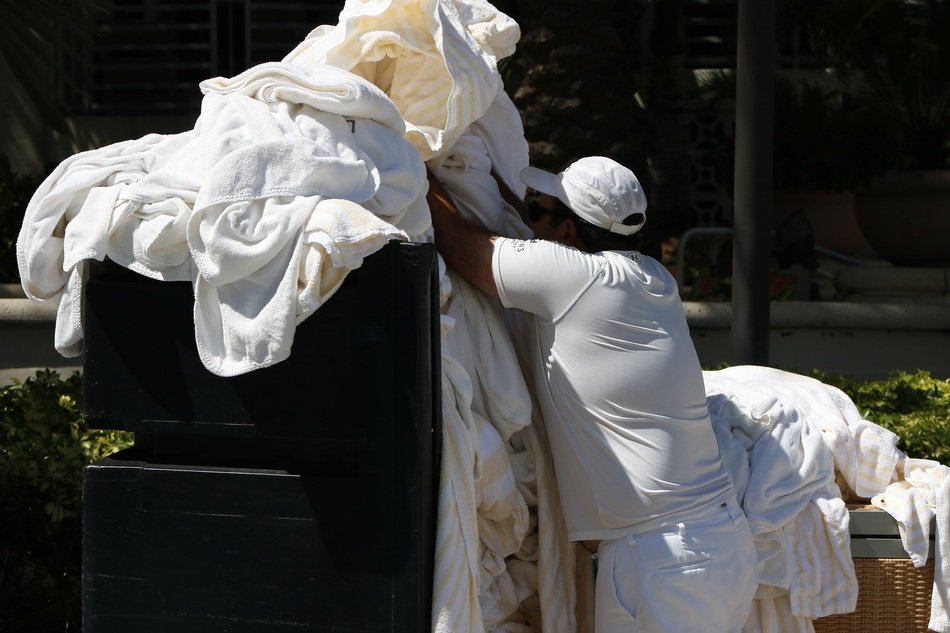 man working with dirty laundry
