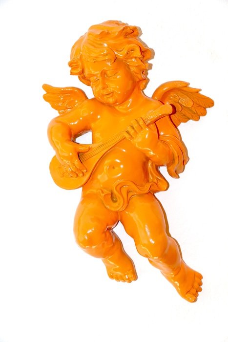golden figure of angel with guitar