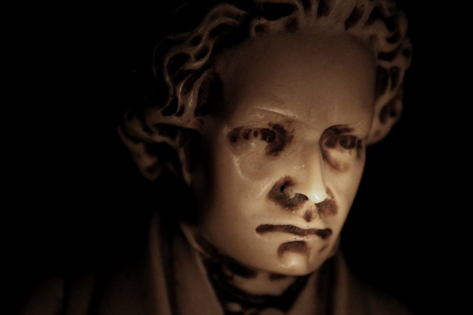 sculpture of beethoven in a dark background