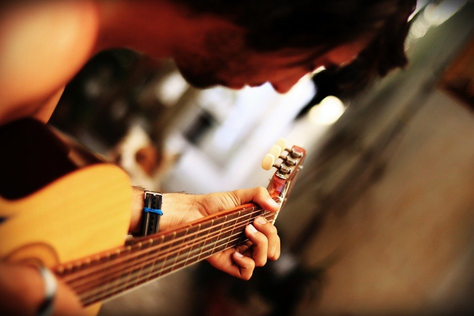 guy plays the guitar