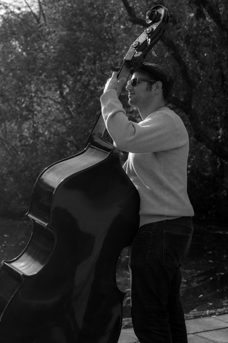 Black and white photo of the double bass player in park