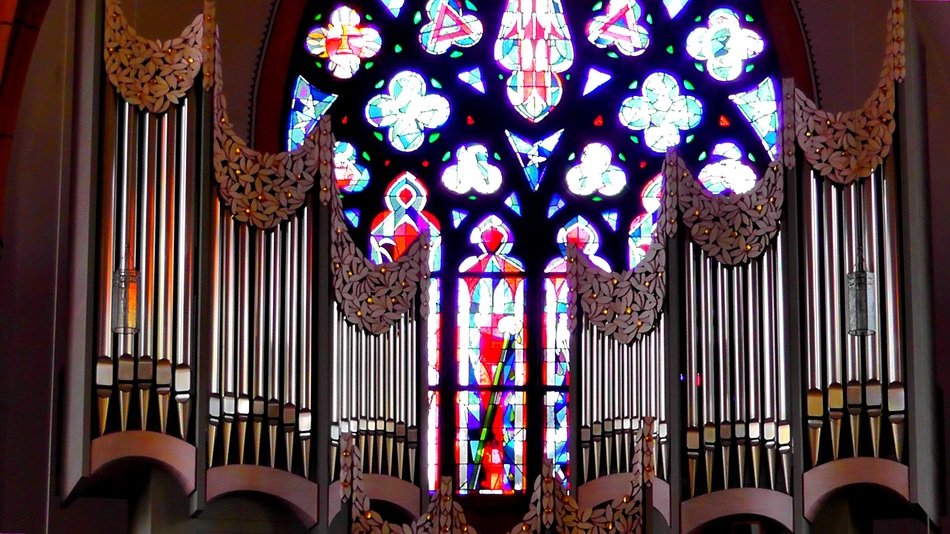 church organ on the stained glass window background