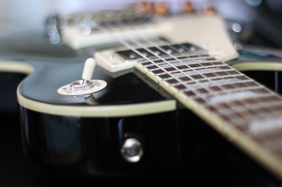 bass guitar in black panel on the table